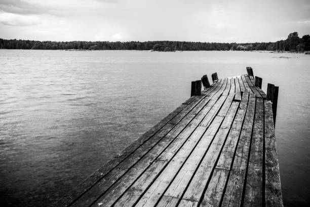 istock Old wooden foot bridge in sea 824773824