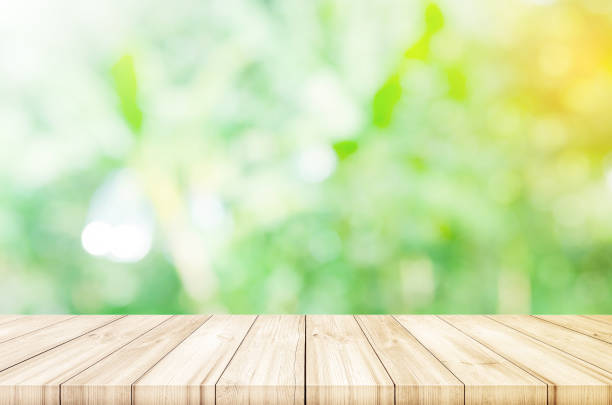 istock Empty wooden table top with blurred green garden background. can be used product display. 824778498