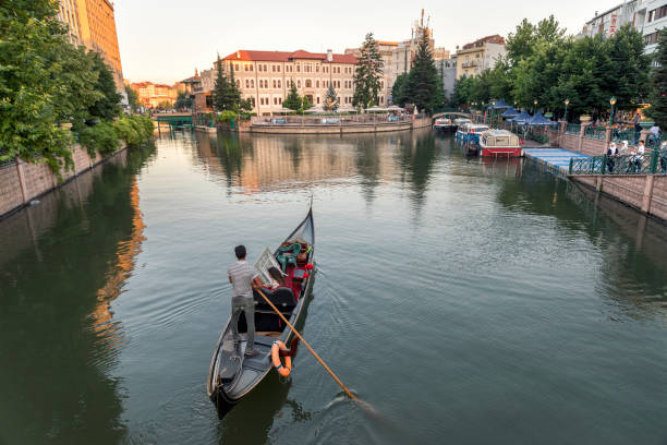 Venice,Italy-Sep.28th 2025: gondolier assists tourists disembarking gondola boat on Venice canal