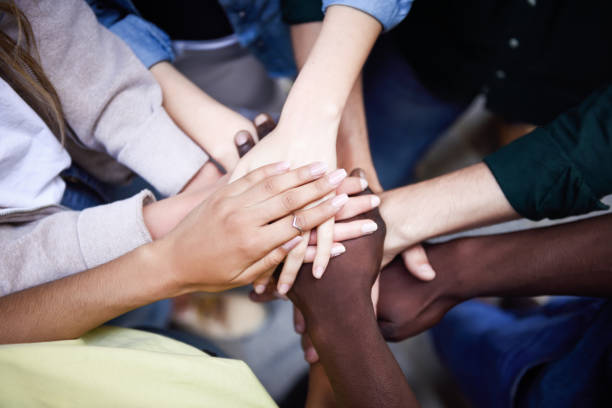 istock Top view of young people putting their hands together. 824781708