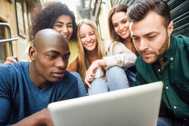 istock Multi-ethnic group of young people looking at a tablet computer 824781808
