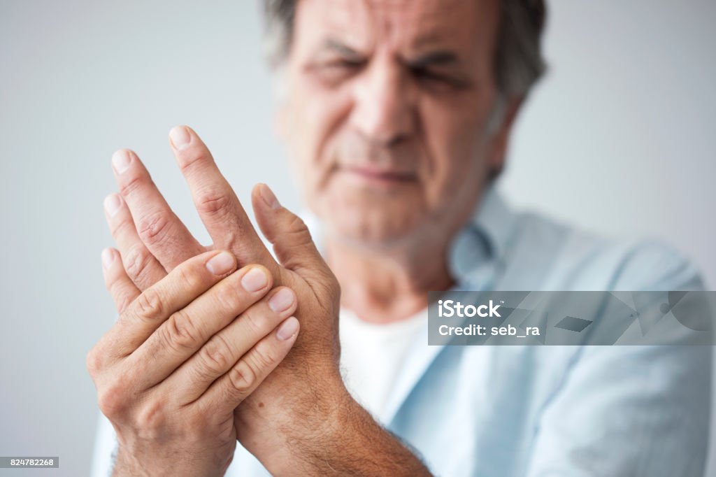 Old man with finger pain Pain Stock Photo