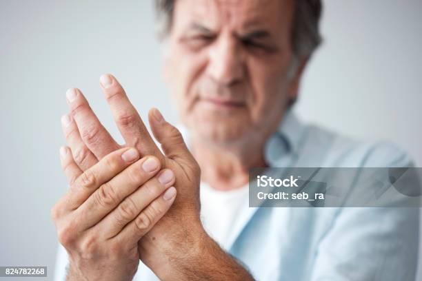 Old Man With Finger Pain Stock Photo - Download Image Now - Pain, Arthritis, Hand