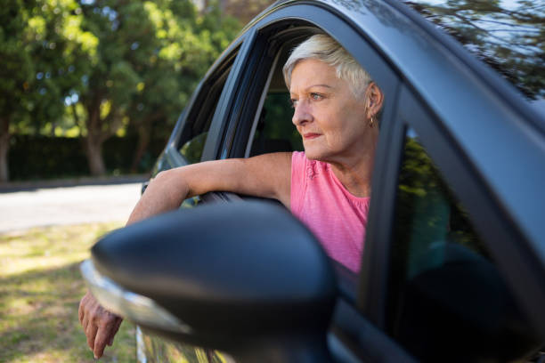 istock Senior woman sitting in a car 824785278