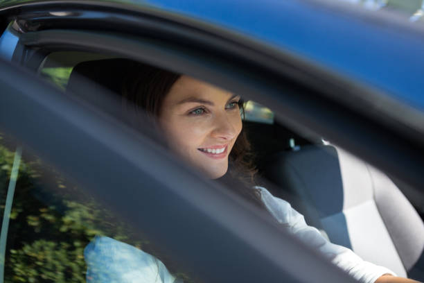 istock Beautiful woman driving a car 824785358