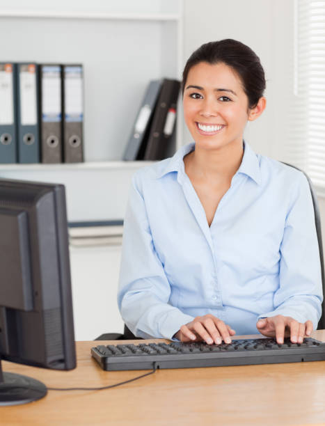 istock Good looking woman typing on a keyboard while sitting 824785566