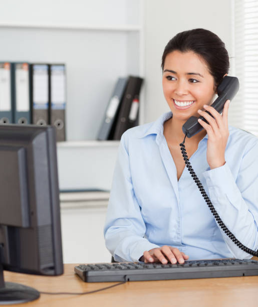 istock Beautiful woman on the phone while typing on a keyboard 824785616