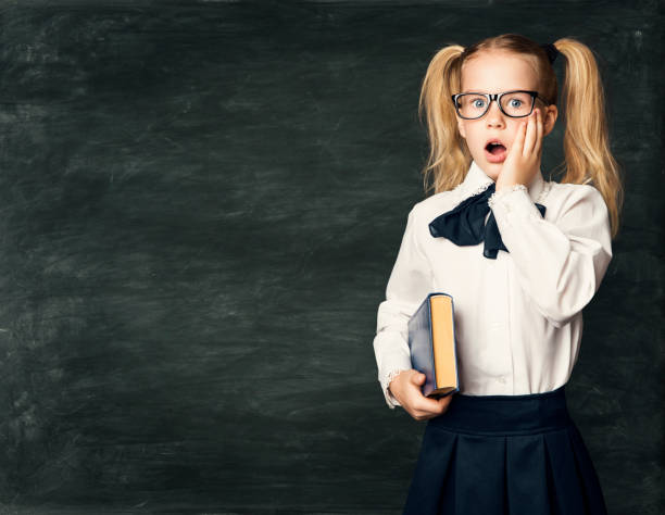 School Child Girl Amazed Face over Blackboard, Surprised Kid with Astonished Emotion School Child Girl Amazed Face over Blackboard, Surprised Kid with Astonished Emotion, Open Mouth Hand on Face Cheek blackboard child shock screaming stock pictures, royalty-free photos & images