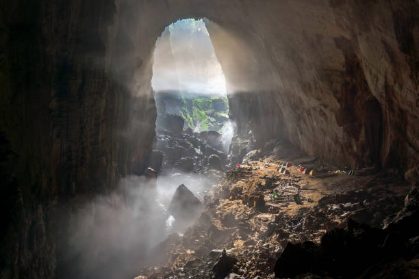 World's Largest Cave - Han Son Doong The world's biggest cave Hang Son Doong is located in the heart of the Phong Nha-Ke Bang National Park in Vietnam. It stretches more than 5 kilometers long with the height of nearly 200 meters. cave stock pictures, royalty-free photos & images