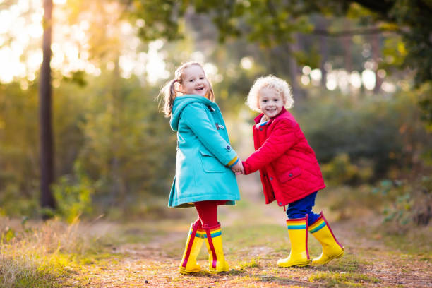 istock Kids play in autumn park. Children in fall. 824793768