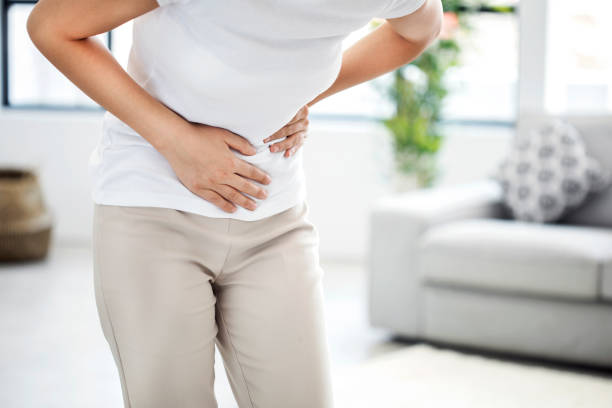 istock Young woman with stomach pain 824794100