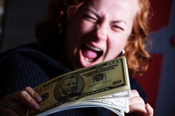 istock Joyful woman with wad of 50 Dollar notes 824796348