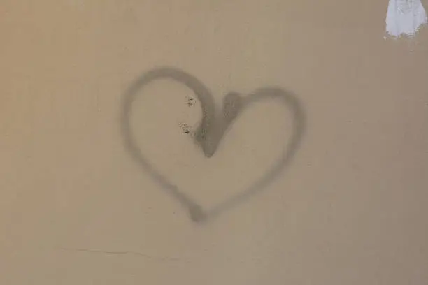 a heart on a wall in a city