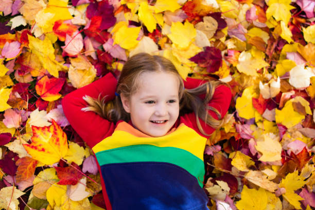 istock Child in fall park. Kid with autumn leaves. 824797814