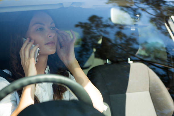 istock Woman talking on mobile phone in a car 824800844