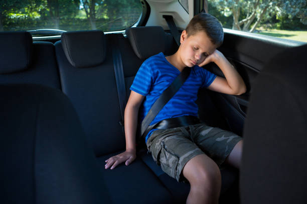 istock Teenage boy sleeping in the car 824801208