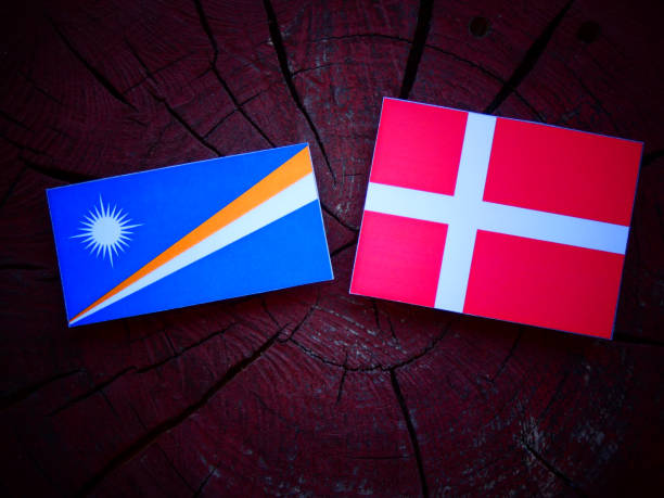 istock Marshall Islands flag with Danish flag on a tree stump isolated 824805618
