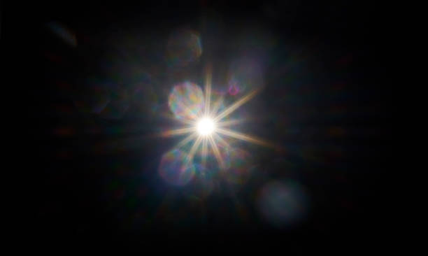 Lens flare generated by flash Flaslight,  overexposure direct light in camera. Aperture spots in different colors spreading out. Dark background flare stack photos stock pictures, royalty-free photos & images