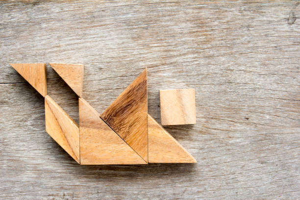 istock Wood tangram puzzle in human stumble and falling shape (Concept for business face the crisis) 824809234