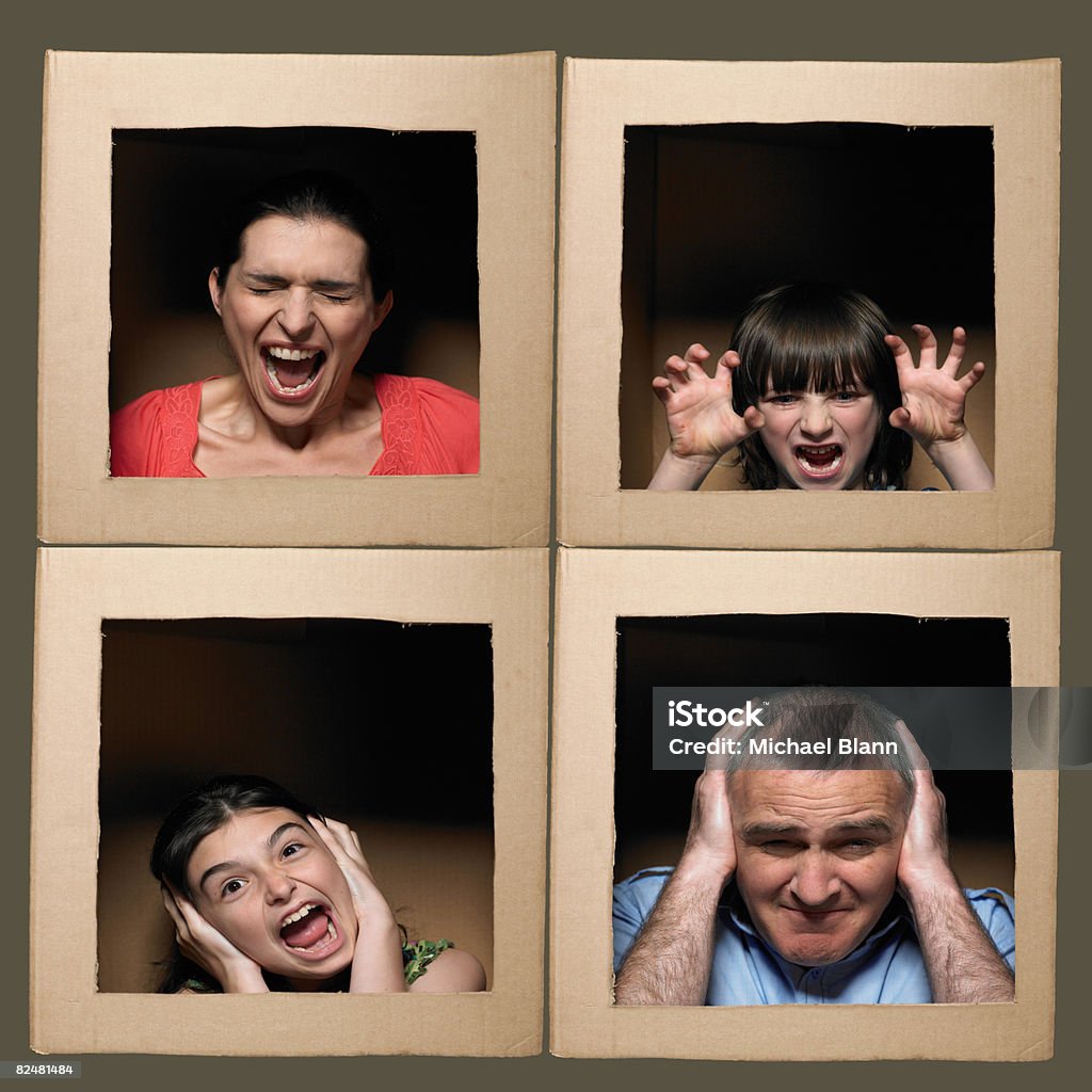 Family with heads in boxes pulling faces  Anger Stock Photo