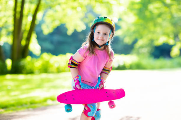 istock Child riding skateboard in summer park 824815372