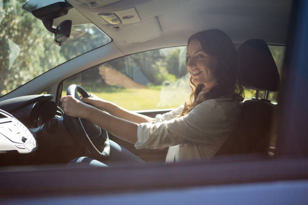 istock Smiling woman driving a car 824815972