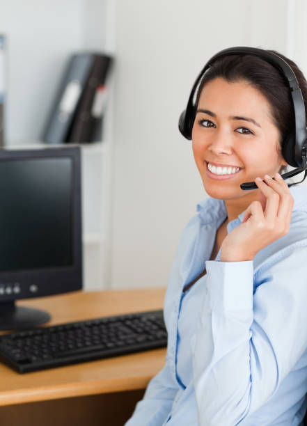 istock Attractive woman wearing a headset and discussing while sitting 824816426
