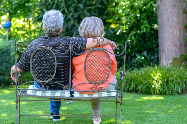 istock Senior couple sitting on bench 824819552