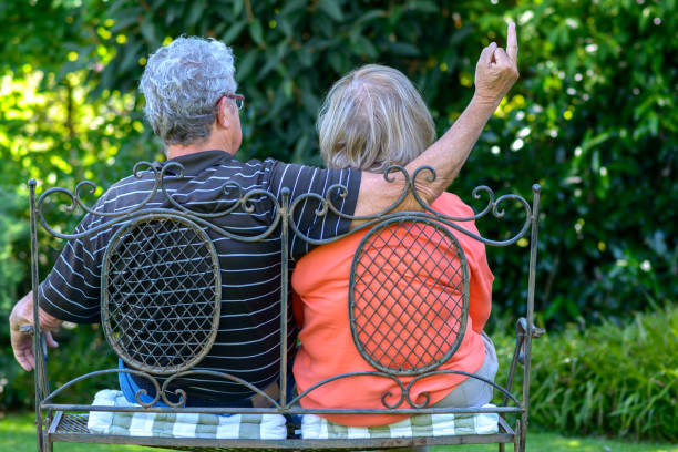 istock Senior couple sitting on a garden bench 824819736