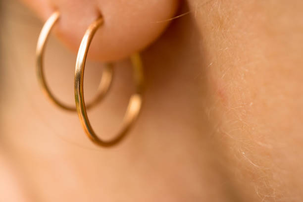 istock Gold earrings in earlobes. Macro 824821072