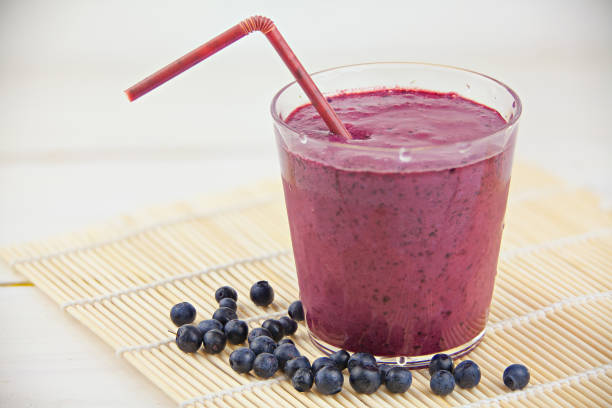 istock Blueberry milkshake in  beautiful glass on white table 824827598