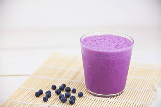 istock Blueberry milkshake in  beautiful glass on white table 824827672