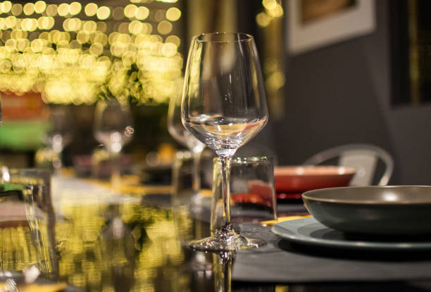istock Two wine glass against christmas lights decoration 824827736