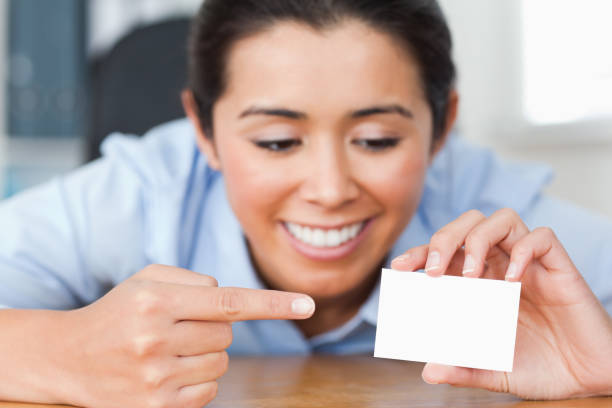 istock Beautiful woman showing her visiting card 824832036
