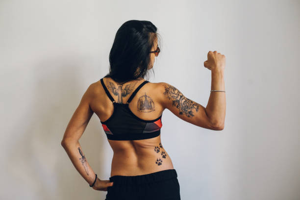 istock Young woman with tattoos relaxing after the training 824832692