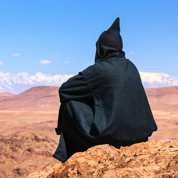 istock Maroccan man looking at High Atlas mountain range 824836130