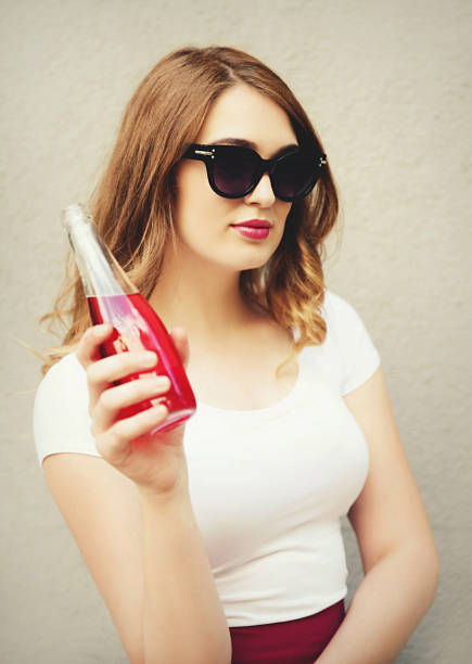 istock Young woman holding bottle with juice 824852394