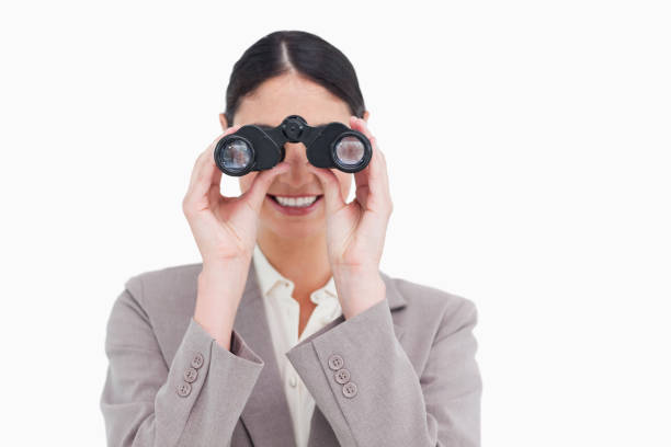 istock Smiling businesswoman looking through spy glasses 824852468