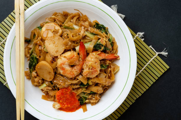 Char kuay teow or flat rice noodles stir fried with seafood stock photo