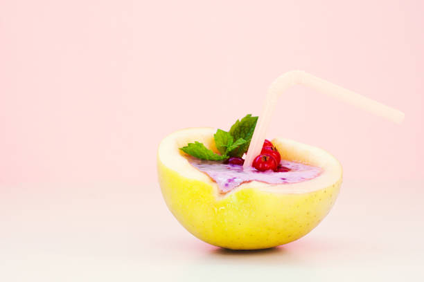 smoothie in apple with blueberry, banana, mint, red currant and milk on pink background. flat lay. minimal and modern summer concept. - blueberry smoothie milk shake drink imagens e fotografias de stock