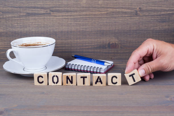 istock contact. Wooden letters on dark background 824863538