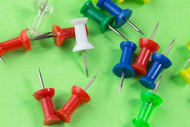 istock pins on green background. Colorful pushpins 824863560