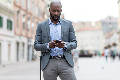 Businessman looking navigation on smart phone.