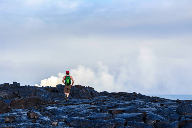 Barren land in Volcanoes national park, lava field, man explores