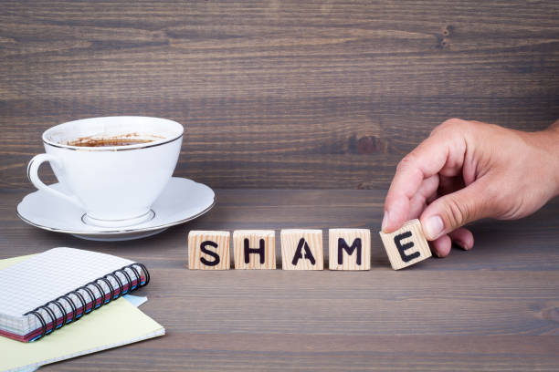 istock shame. Wooden letters on dark background 824865364