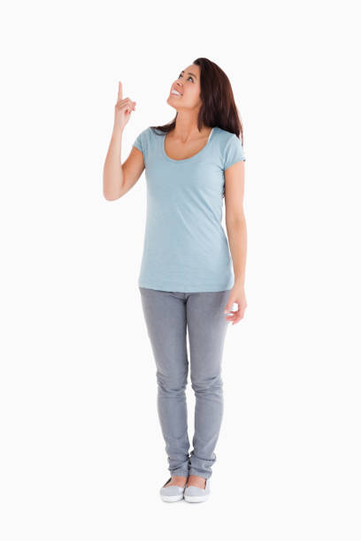 istock Pretty woman showing a copy space with her finger while standing 824867662