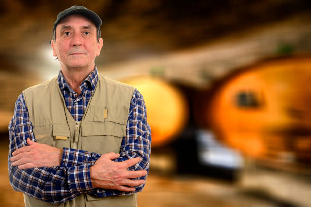 istock Farmer with barrels of wine 824868158