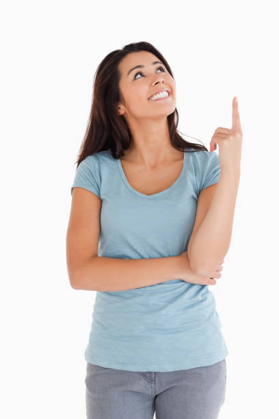 istock Pretty woman showing a copy space with her finger while standing 824868390