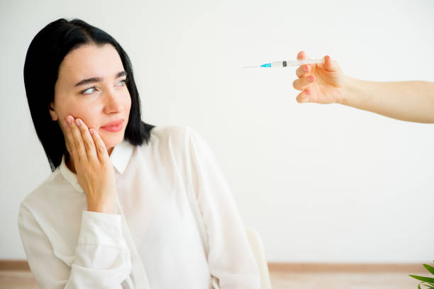 istock Woman gets facial injection 824875470