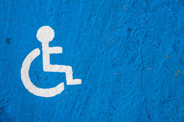 istock White disabled parking sign painted on blue background 824880774